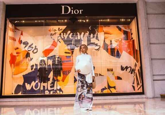 femeie in fata vitrinei unui magazin Dior